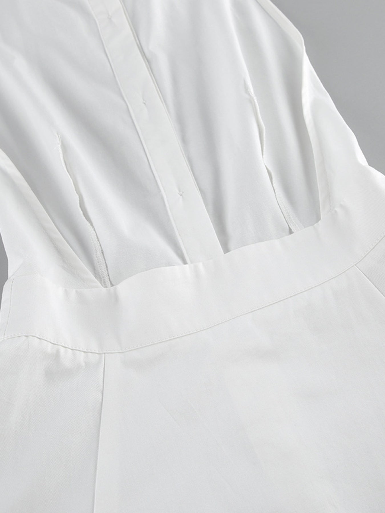 Close-up of a white garment with a focus on texture and folds.