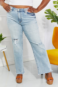 Person wearing light blue jeans with a white background