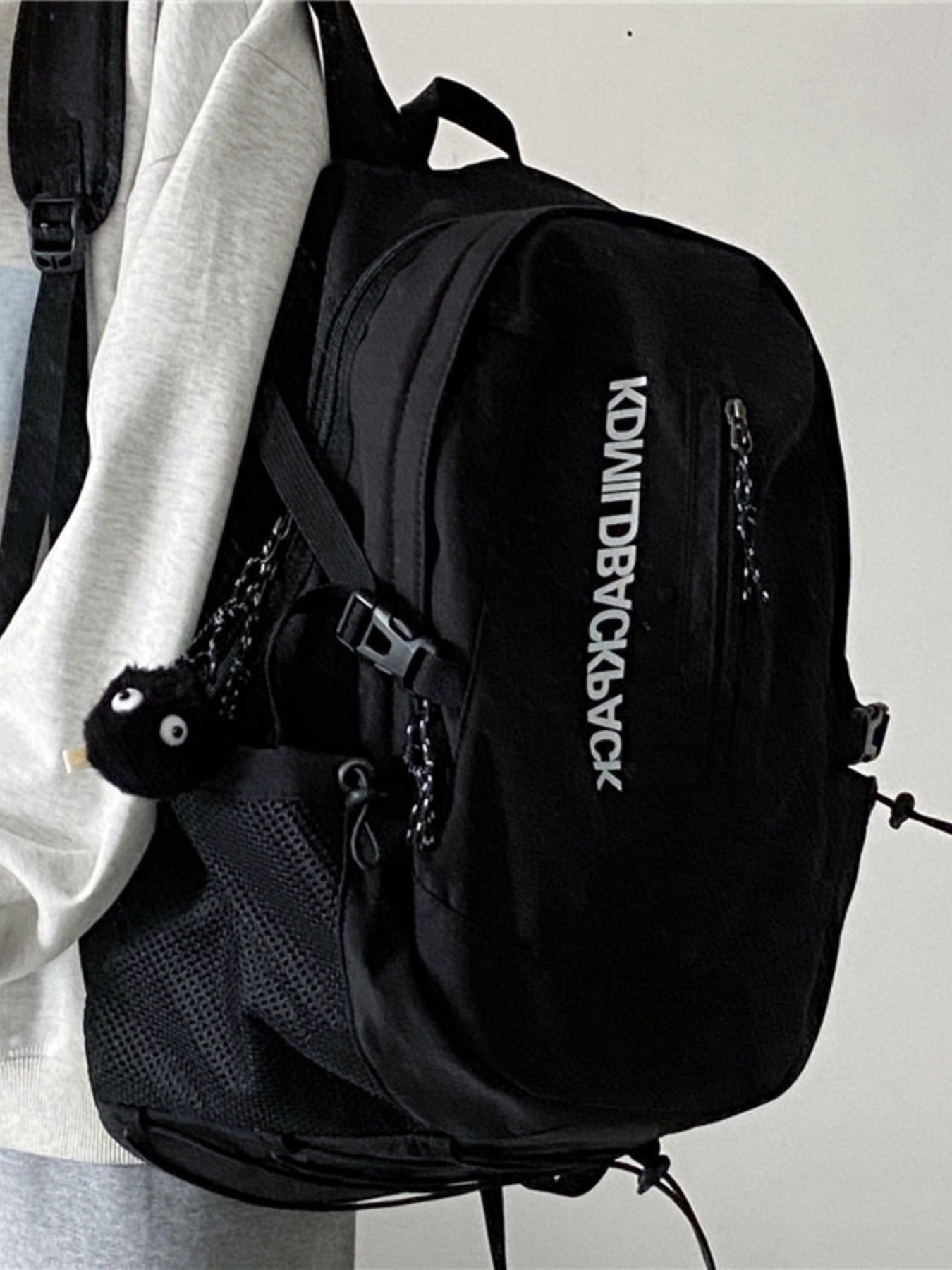 Black backpack with visible brand logo on a plain background