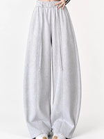 Light gray heathered wide-leg sweatpants with an elastic waistband and drawstring, shown on a model from the waist down against a plain white background.