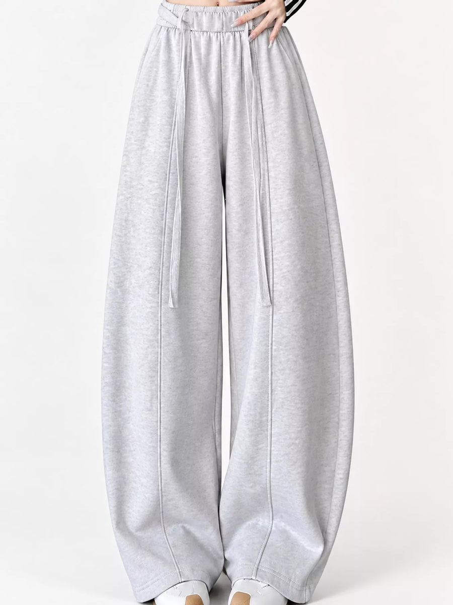 Light gray heathered wide-leg sweatpants with an elastic waistband and drawstring, shown on a model from the waist down against a plain white background.