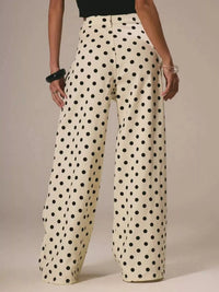 Polka dot pants worn by a person on a neutral background