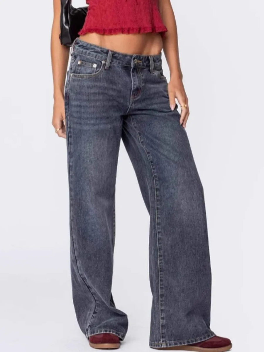 Person wearing blue jeans on a white background