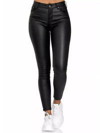 Black leather pants worn by a person on a white background