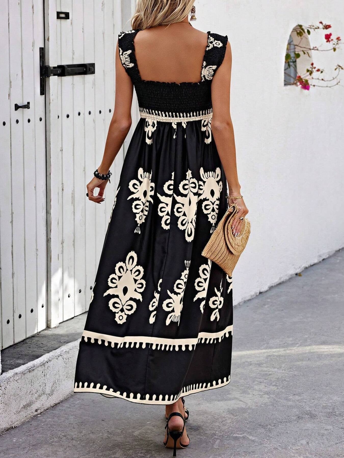 Woman wearing a black dress with white embroidery walking on a street.