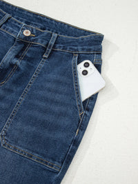 Blue jeans with a white phone on a light gray background