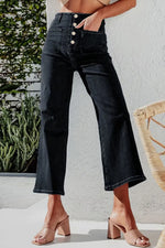 Person wearing dark blue jeans with a white background