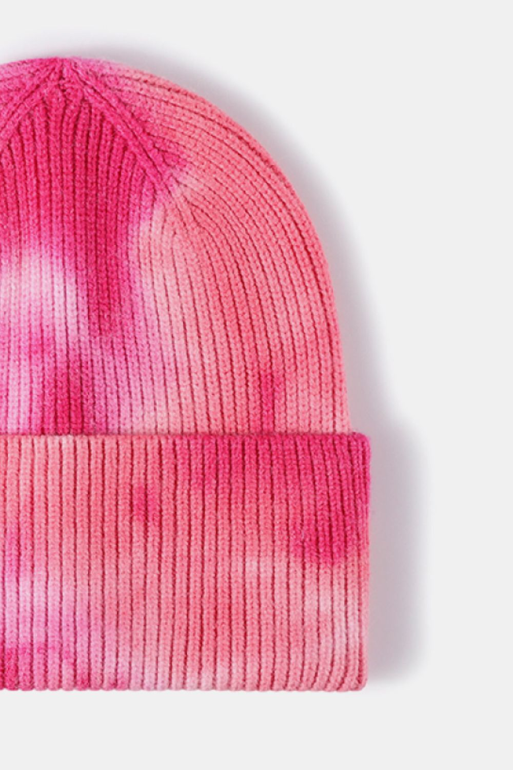 Pink and white tie-dye beanie on a light gray background