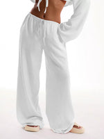White lounge pants worn by a person on a white background