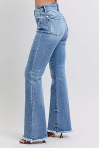 Light blue flared jeans on a white background