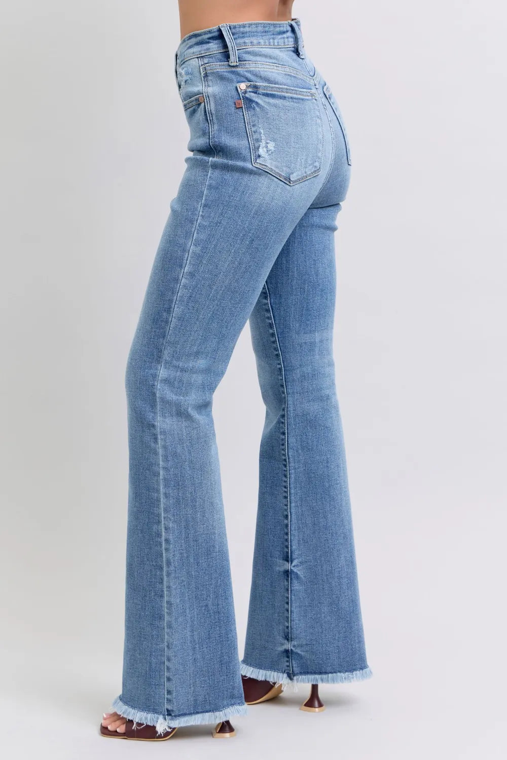 Light blue flared jeans on a white background