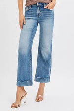 Light blue jeans worn by a person on a white background