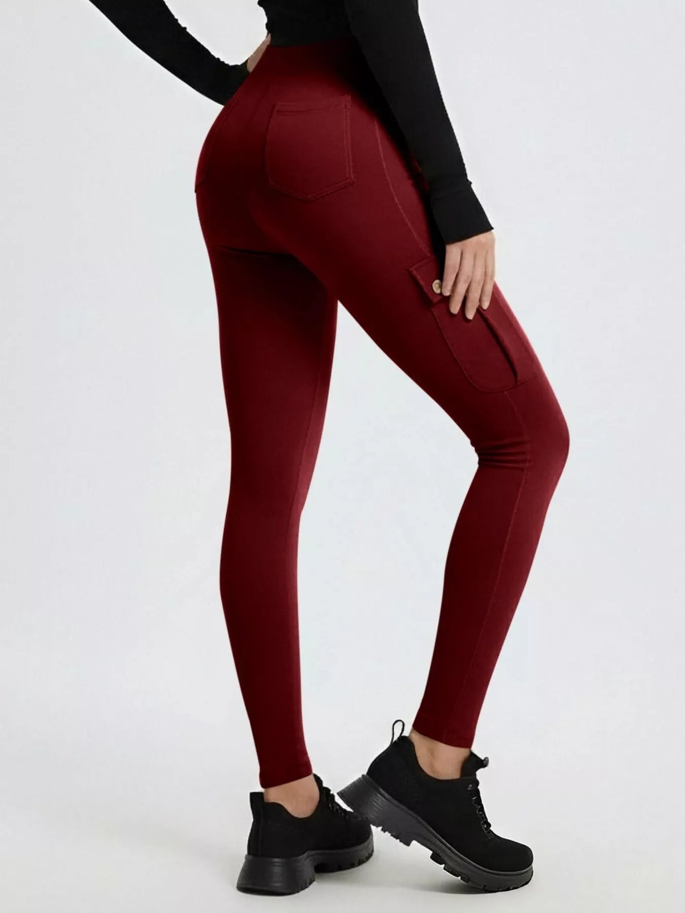Maroon leggings worn by a person on a white background