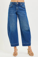 Blue jeans worn by a person on a white background