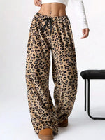Leopard print pants worn by a person on a white background