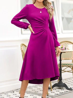 Woman wearing a purple dress in an indoor setting