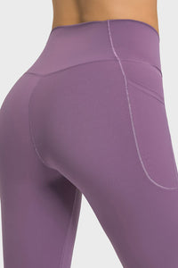 Close-up of purple leggings with a plain background