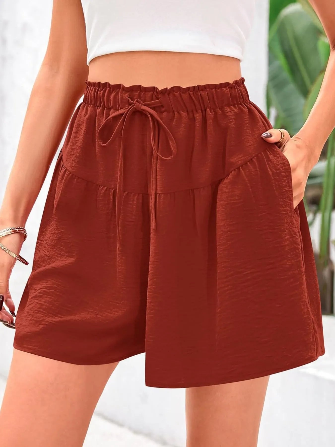 Brown shorts worn by a person with a blurred background