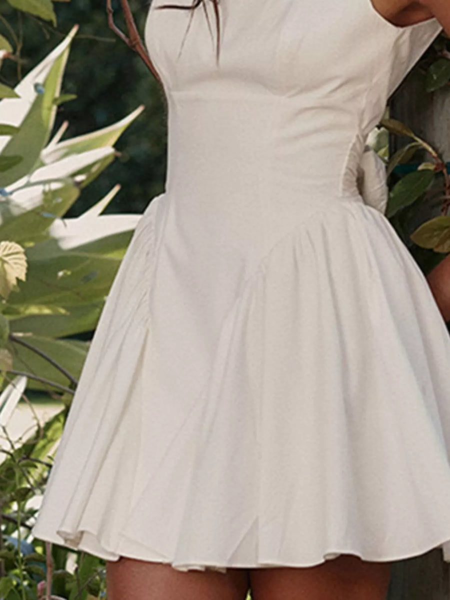 White dress worn by a person with a blurred natural background
