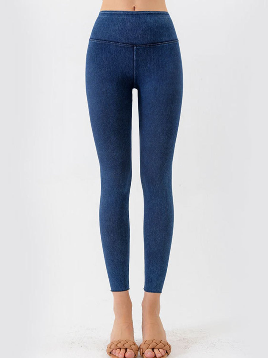 Blue leggings worn by a person on a white background