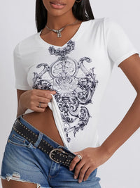 Person wearing a white t-shirt with black intricate design and blue jeans on a white background