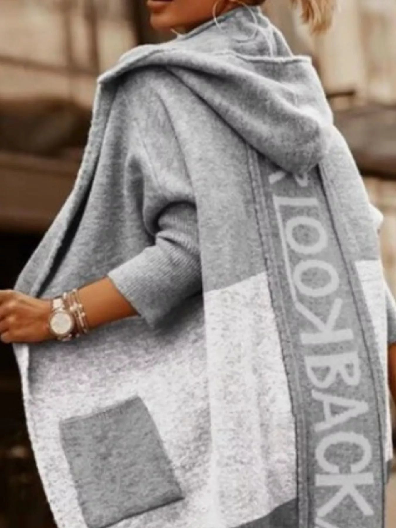 Gray poncho with 'Lookbook' branding worn by a person