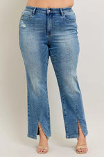 Blue jeans with a front slit on a plain background