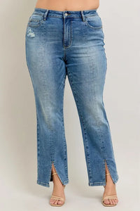 Blue jeans with a front slit on a plain background