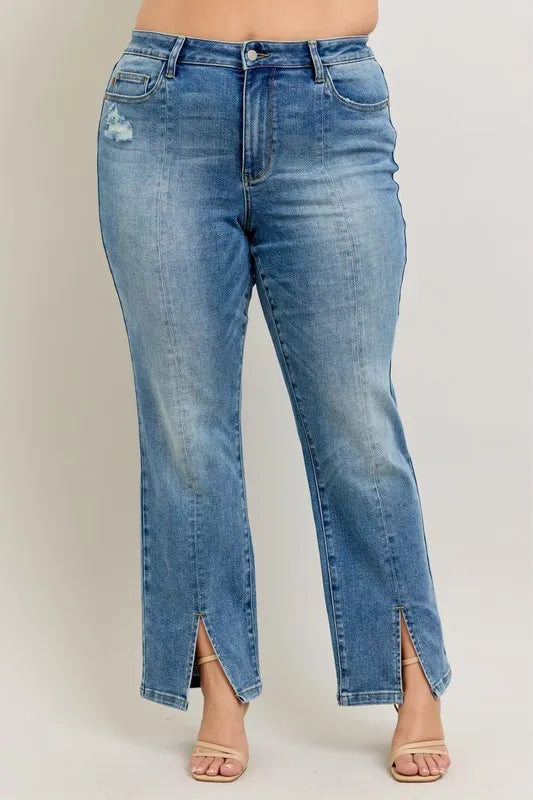 Blue jeans with a front slit on a plain background