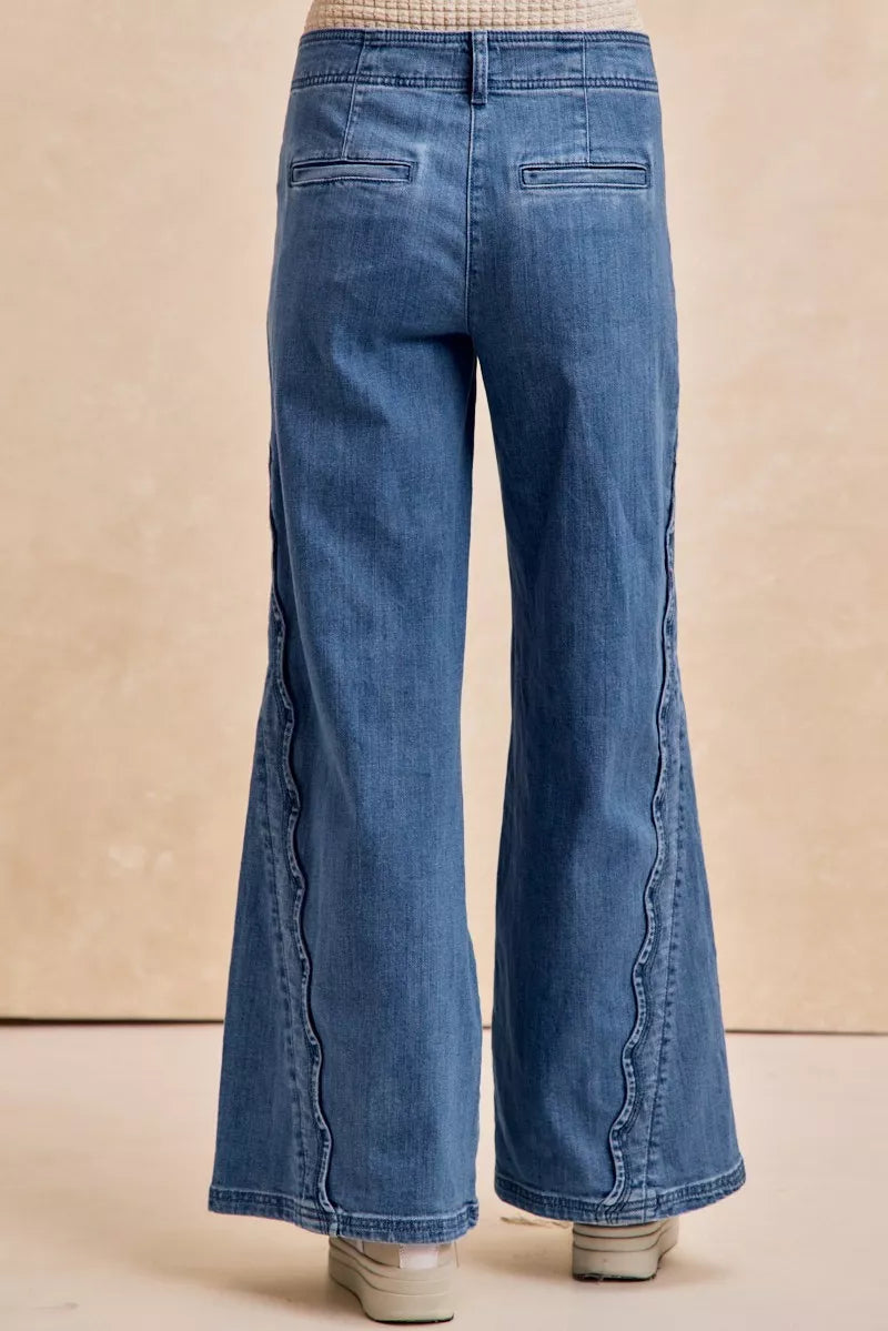 Blue flared jeans on a beige background