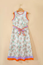 Floral dress with colorful trim on a beige background