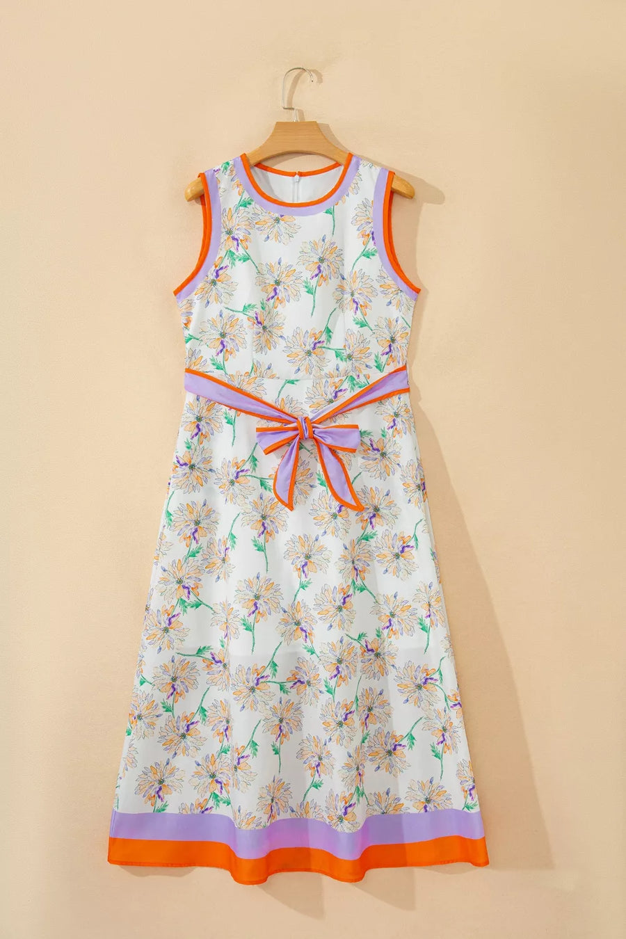Floral dress with colorful trim on a beige background