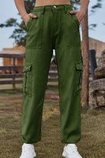 Person wearing green cargo pants with a blurred outdoor background