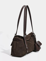 Brown leather handbag with shoulder strap on a white background