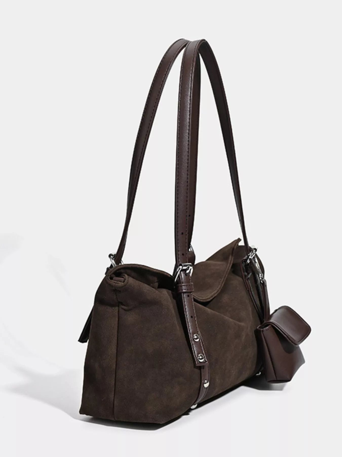 Brown leather handbag with shoulder strap on a white background