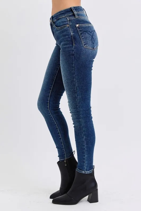 Blue jeans worn by a person on a white background