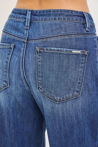 Close-up of blue jeans with a focus on the back pocket.