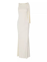 White evening gown with a draped design on a white background