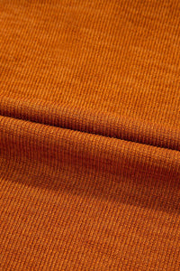 Close-up of brown fabric with a visible seam