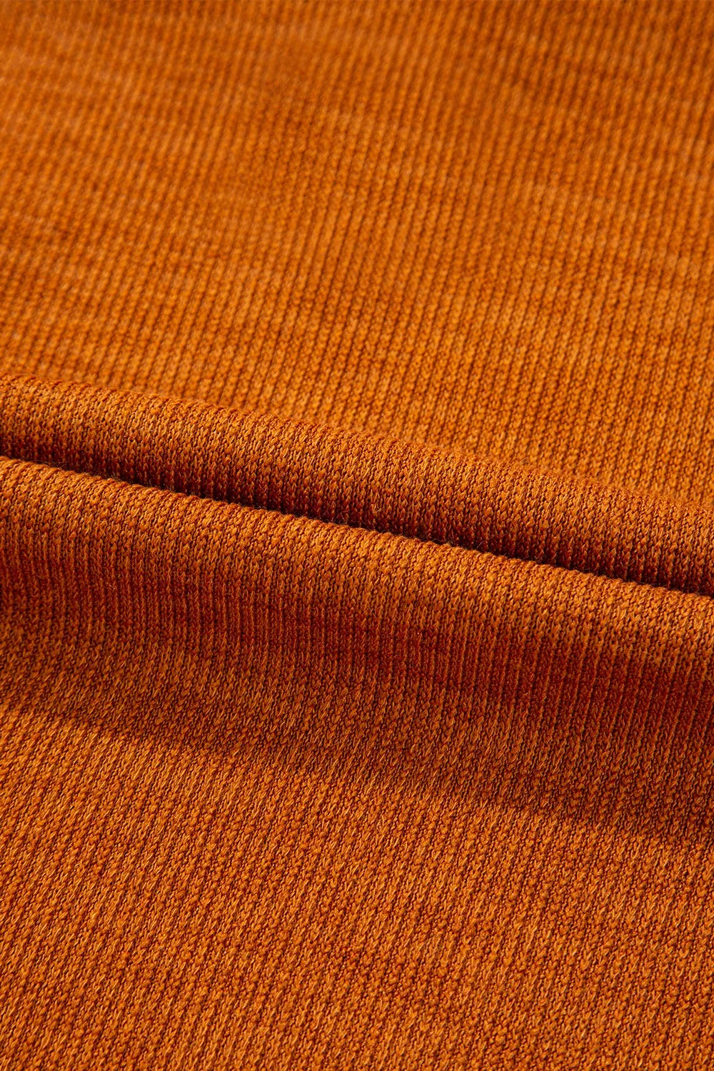 Close-up of brown fabric with a visible seam