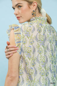Woman wearing a floral blouse against a light blue background