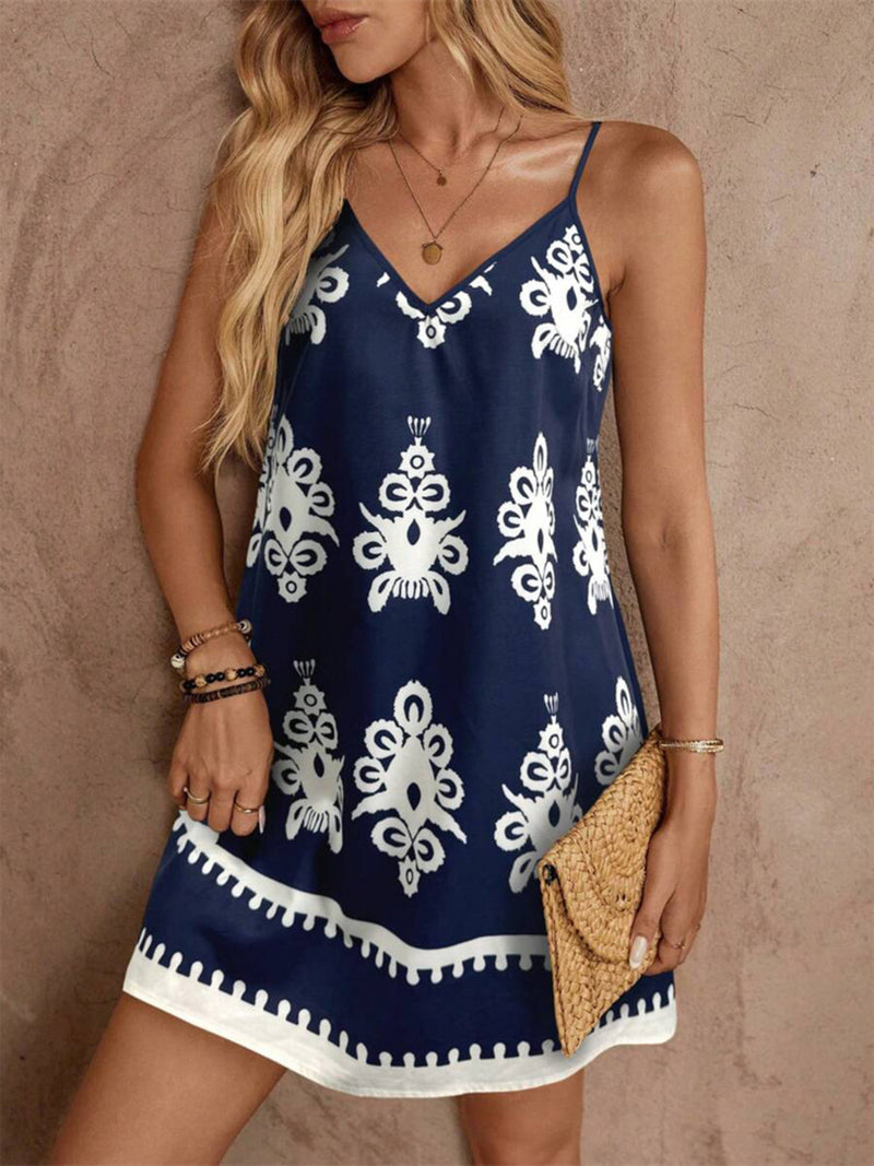 Woman wearing a navy blue dress with white patterns against a beige background