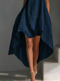 Navy blue dress with a high-low hem on a gray background