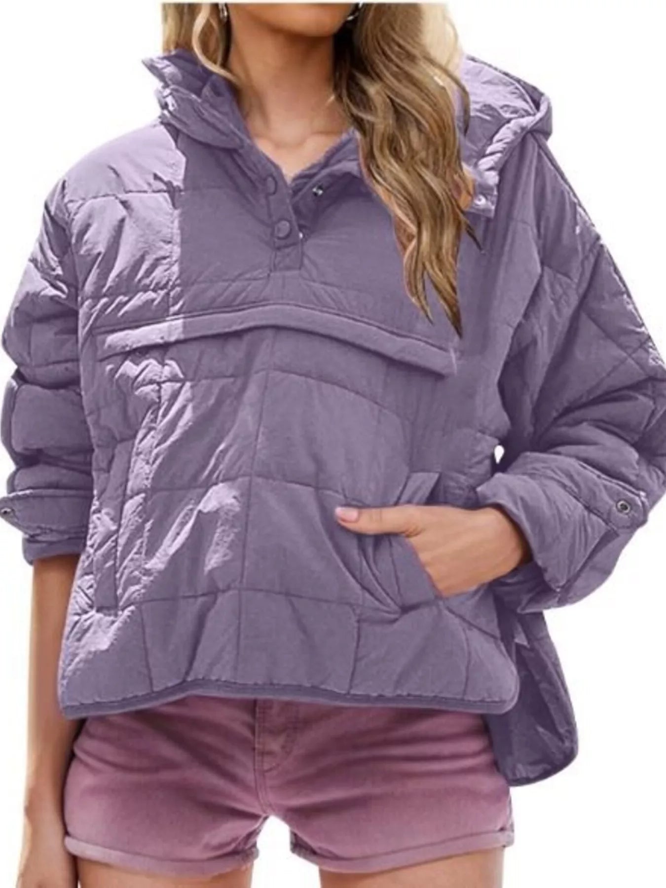 Person wearing a purple quilted jacket on a white background