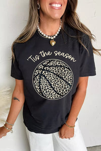 Person wearing a black t-shirt with 'Tis the season' and leopard print design.