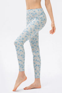 Light blue floral-patterned leggings worn by a person on a white background