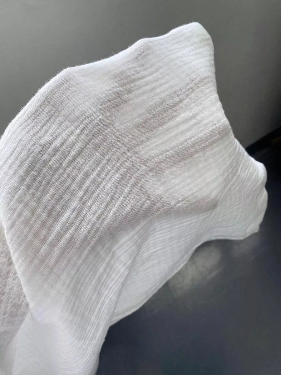 Close-up of a white sock on a dark background