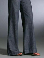 Blue denim pants on a gray background