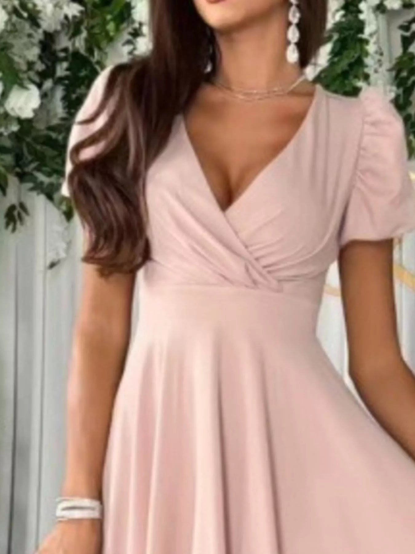 Woman wearing a pink dress with a blurred background
