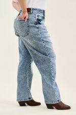 Light blue jeans worn by a person on a white background